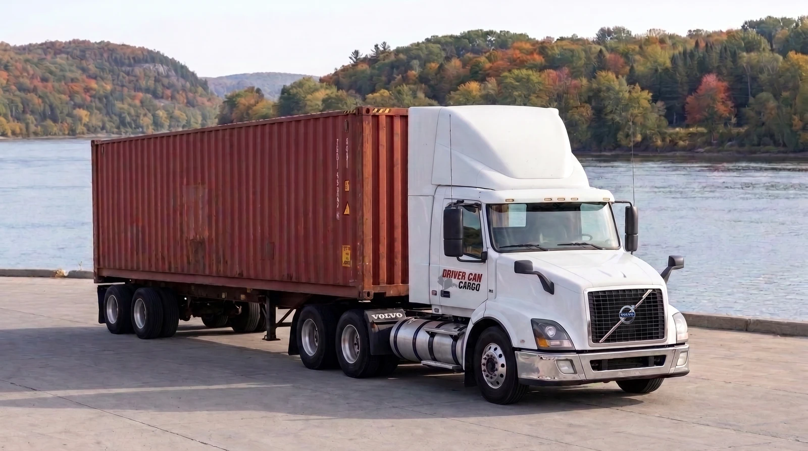 White Volvo tractor with a raised white roof fairing and a dry container.