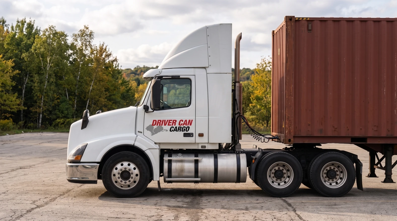 White Volvo tractor with a raised white roof fairing and a dry container.
