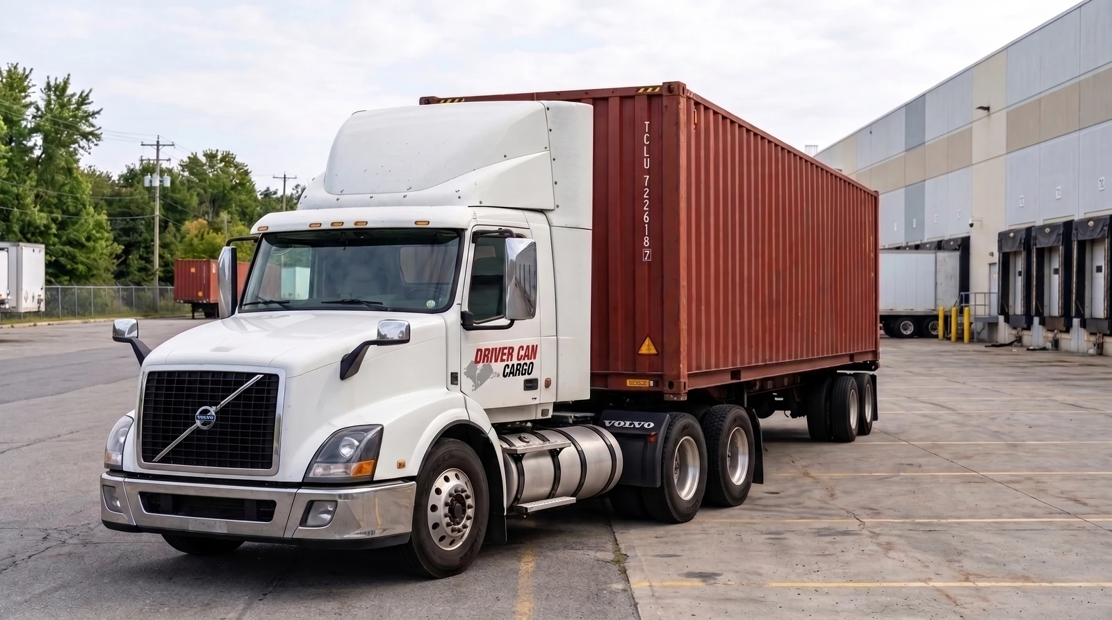 White Volvo tractor with a raised white roof fairing and a dry container.